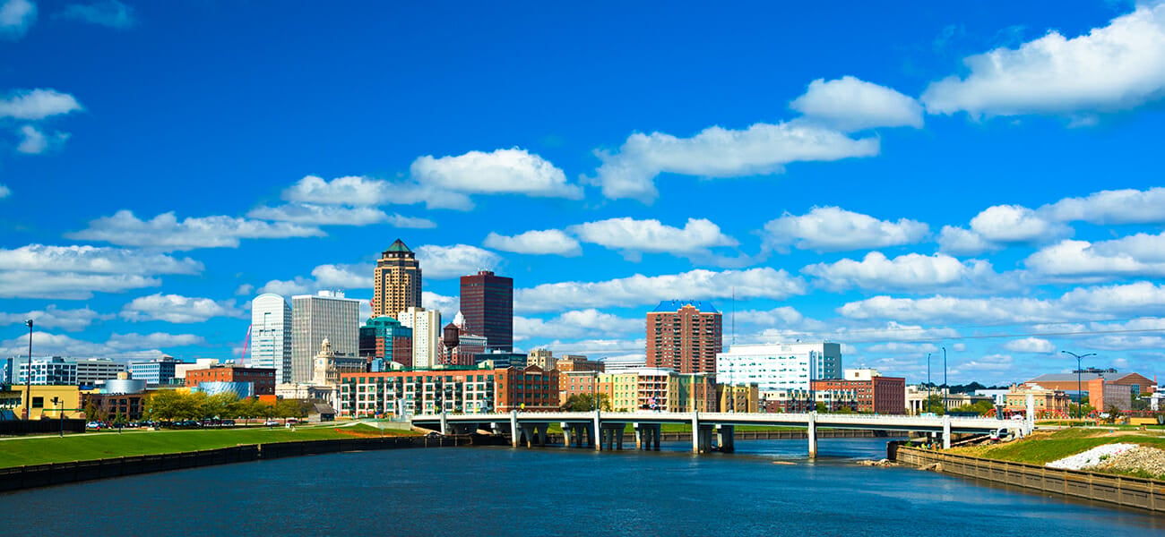 Des Moines skyline with puffy clouds and river